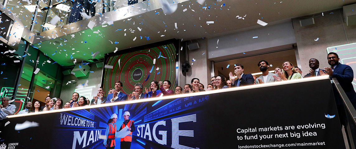 The team celebrating on the balcony at LSEG during the welcome ceremony.