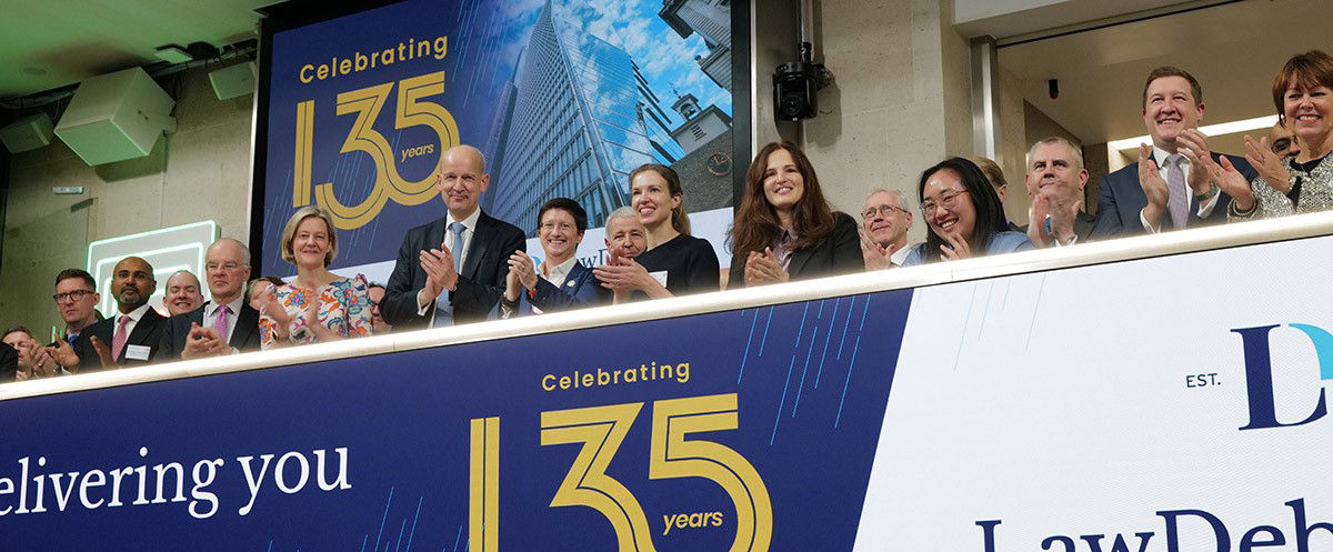 The team celebrating on the balcony at LSEG during the welcome ceremony.