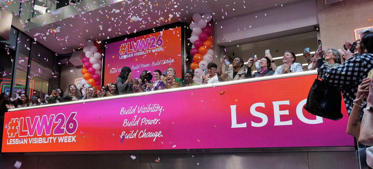 The team celebrating on the balcony at LSEG during the welcome ceremony.