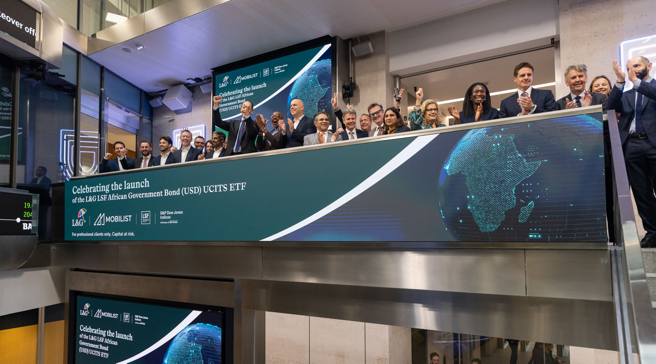 The team celebrating on the balcony at LSEG during the welcome ceremony.
