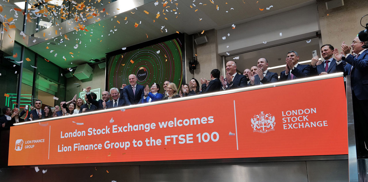 The team celebrating on the balcony at LSEG during the welcome ceremony.