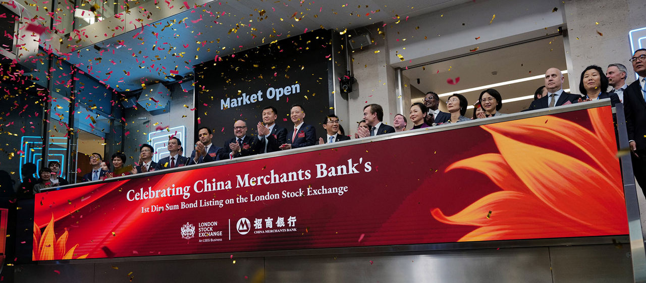 The team celebrating on the balcony at LSEG during the welcome ceremony.