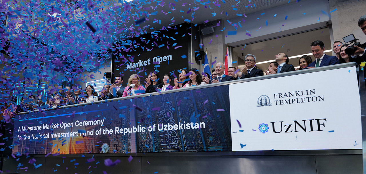 The team celebrating on the balcony at LSEG during the welcome ceremony.