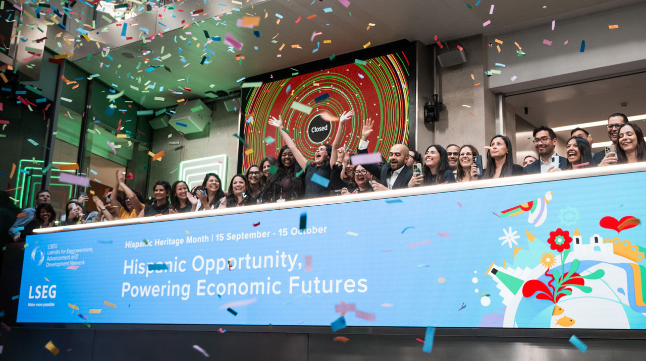 The team celebrating on the balcony at LSEG during the welcome ceremony.
