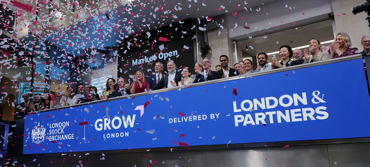 The team celebrating on the balcony at LSEG during the welcome ceremony.