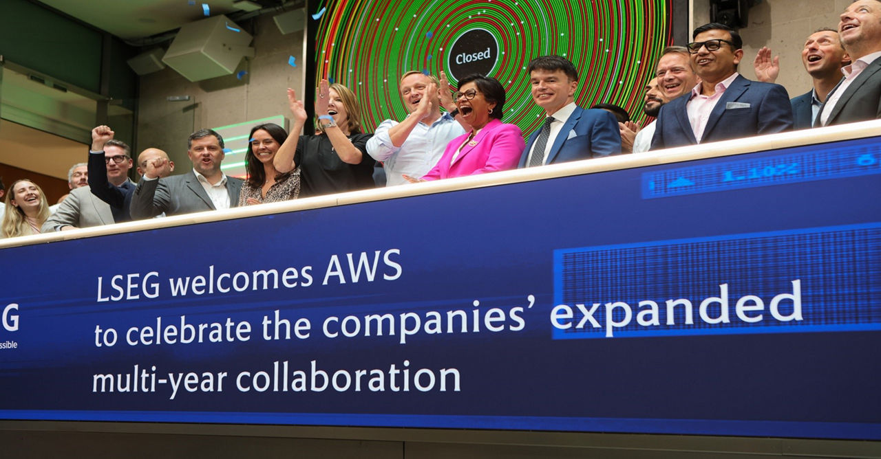 The team celebrating on the balcony at LSEG during the welcome ceremony.
