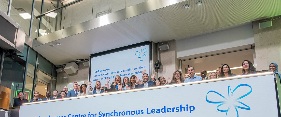 The team celebrating on the balcony at LSEG during the welcome ceremony.