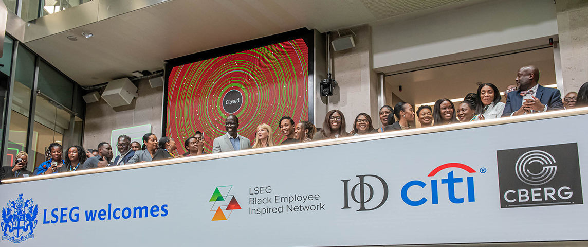 The team celebrating on the balcony at LSEG during the welcome ceremony.