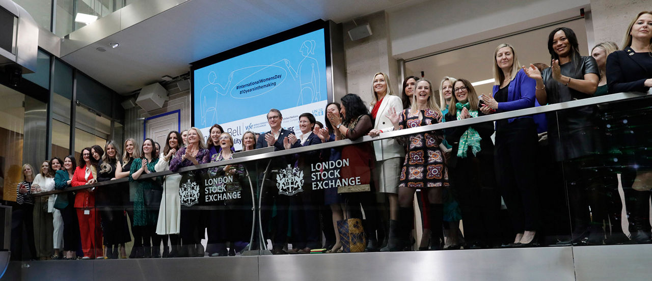 The team celebrating on the balcony at LSEG during the welcome ceremony.