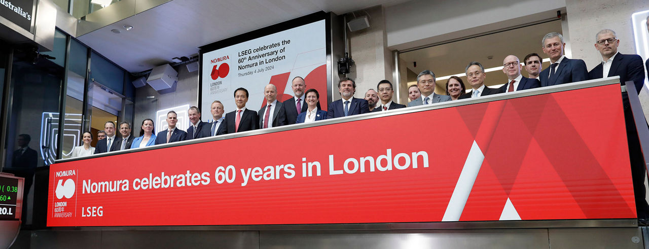 The team celebrating on the balcony at LSEG during the welcome ceremony.