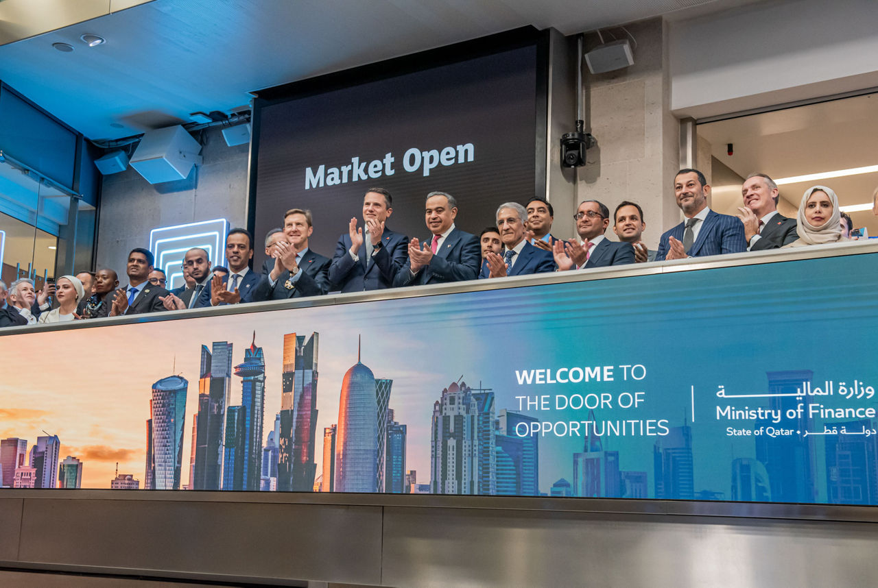 The team celebrating on the balcony at LSEG during the welcome ceremony.