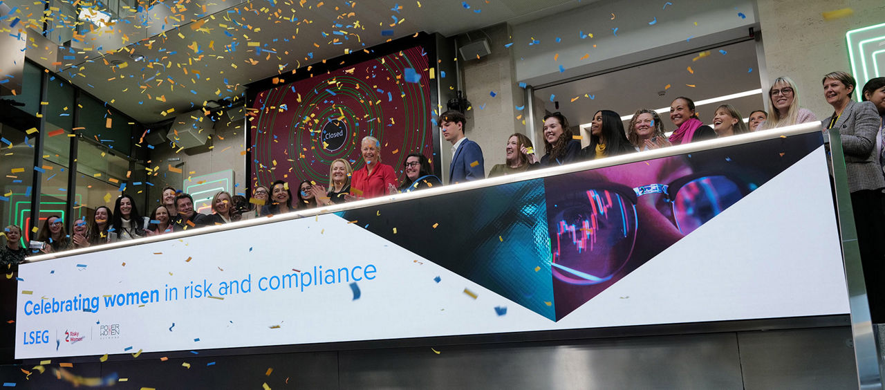 The team celebrating on the balcony at LSEG during the welcome ceremony.