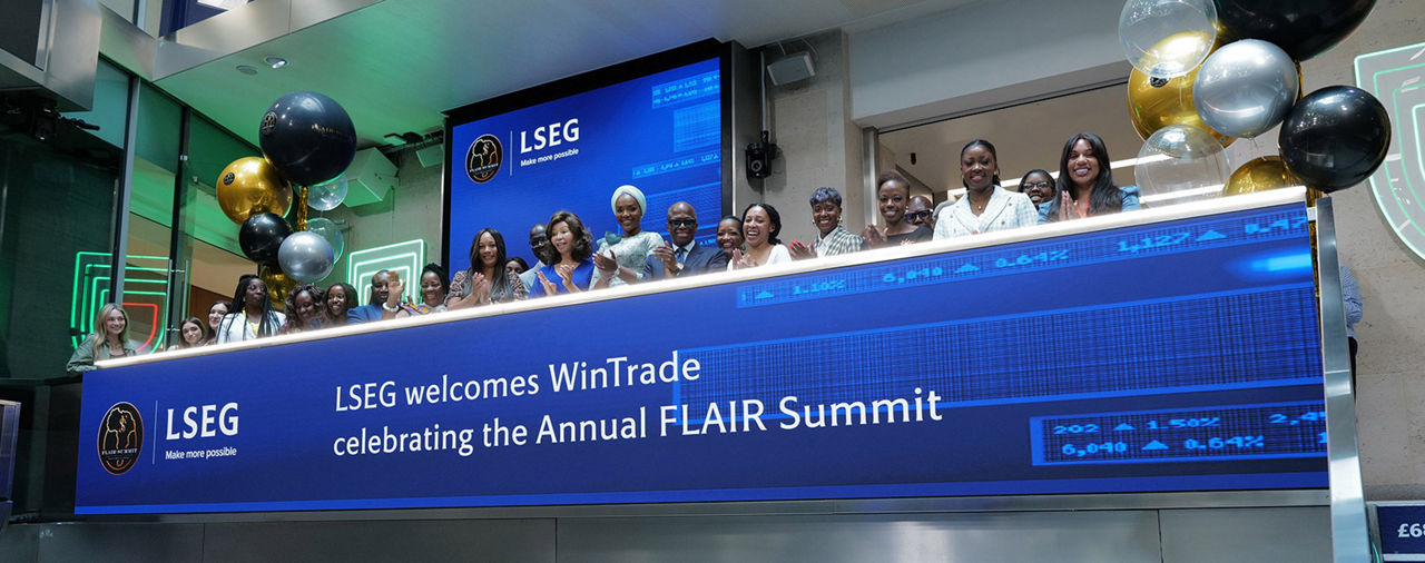 The team celebrating on the balcony at LSEG during the welcome ceremony.