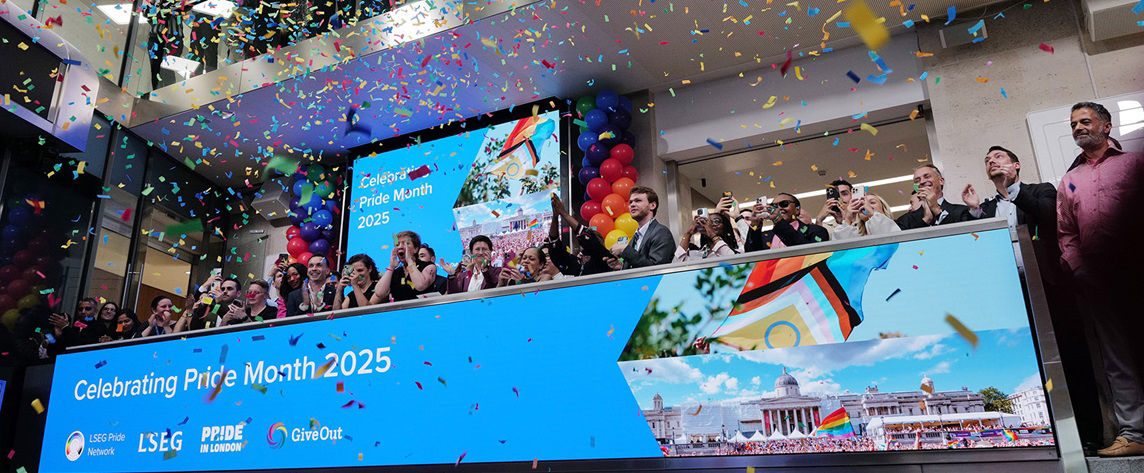 The team celebrating on the balcony at LSEG during the welcome ceremony.