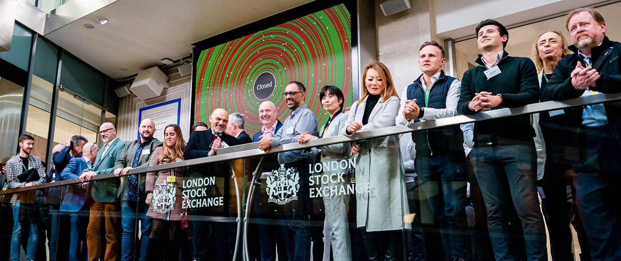 The team celebrating on the balcony at LSEG during the welcome ceremony.