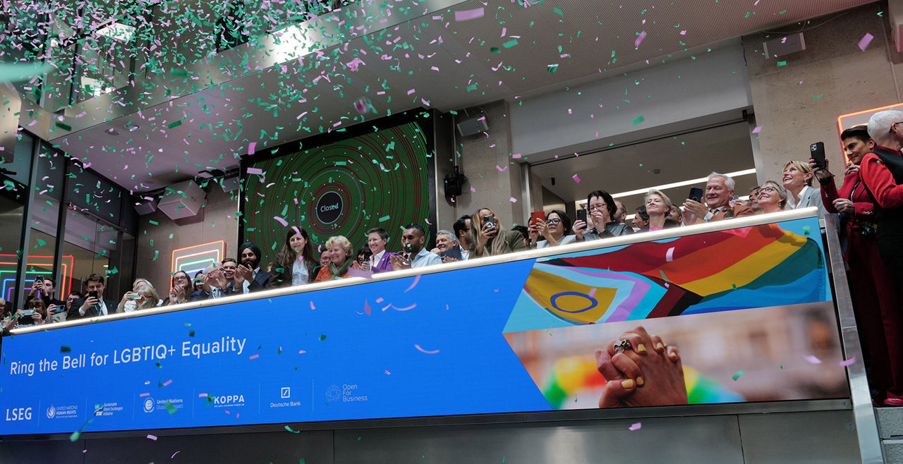 The team celebrating on the balcony at LSEG during the welcome ceremony.