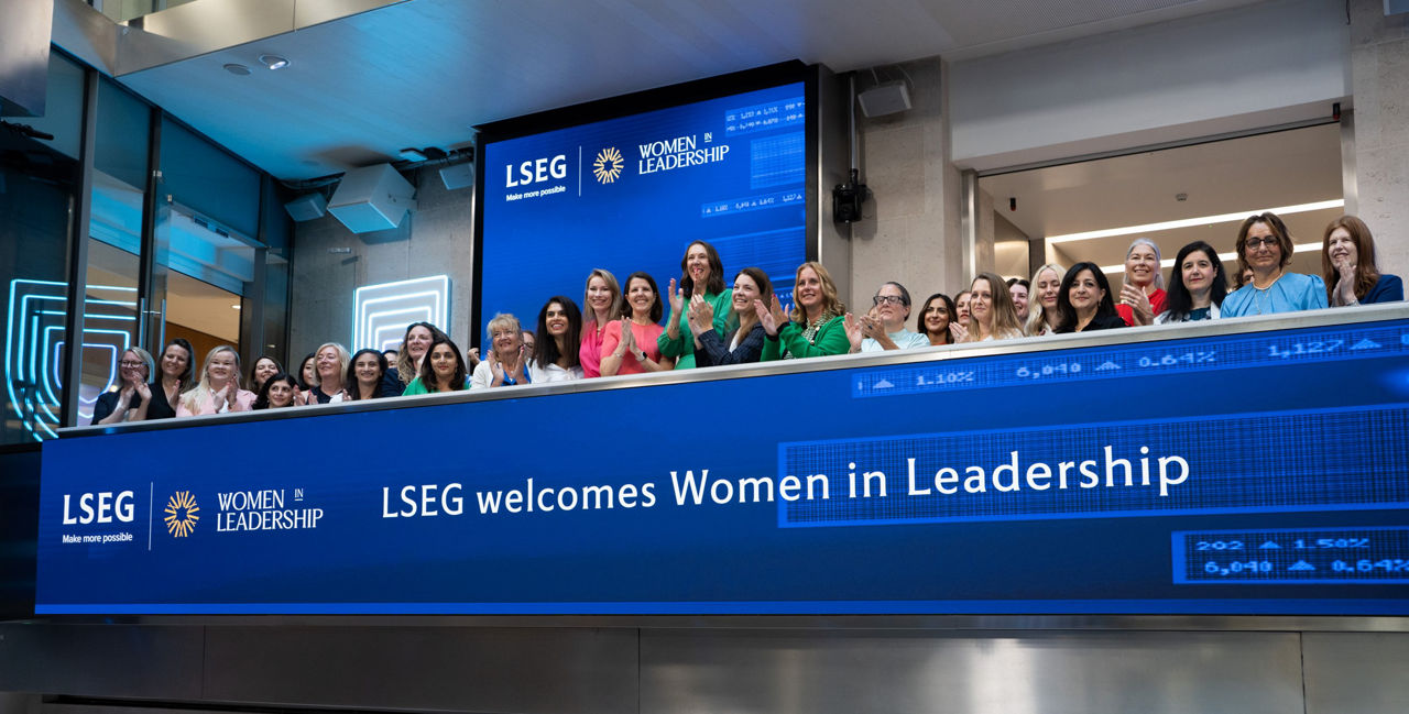 The team celebrating on the balcony at LSEG during the welcome ceremony.