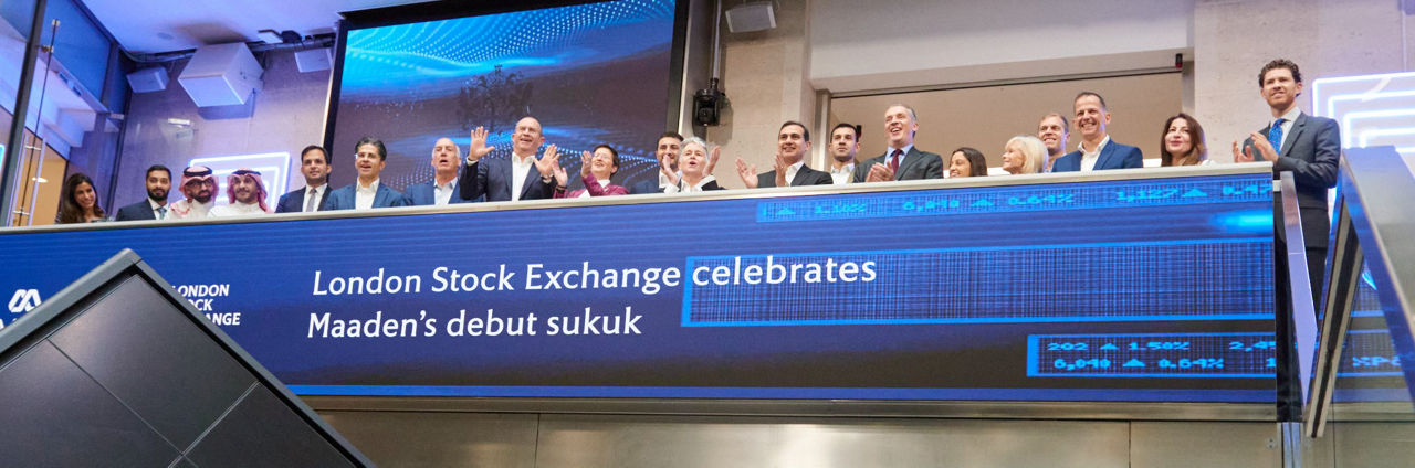 The team celebrating on the balcony at LSEG during the welcome ceremony.