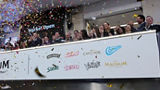 The team celebrating on the balcony at LSEG during the welcome ceremony.
