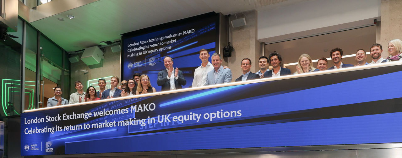 The team celebrating on the balcony at LSEG during the welcome ceremony.