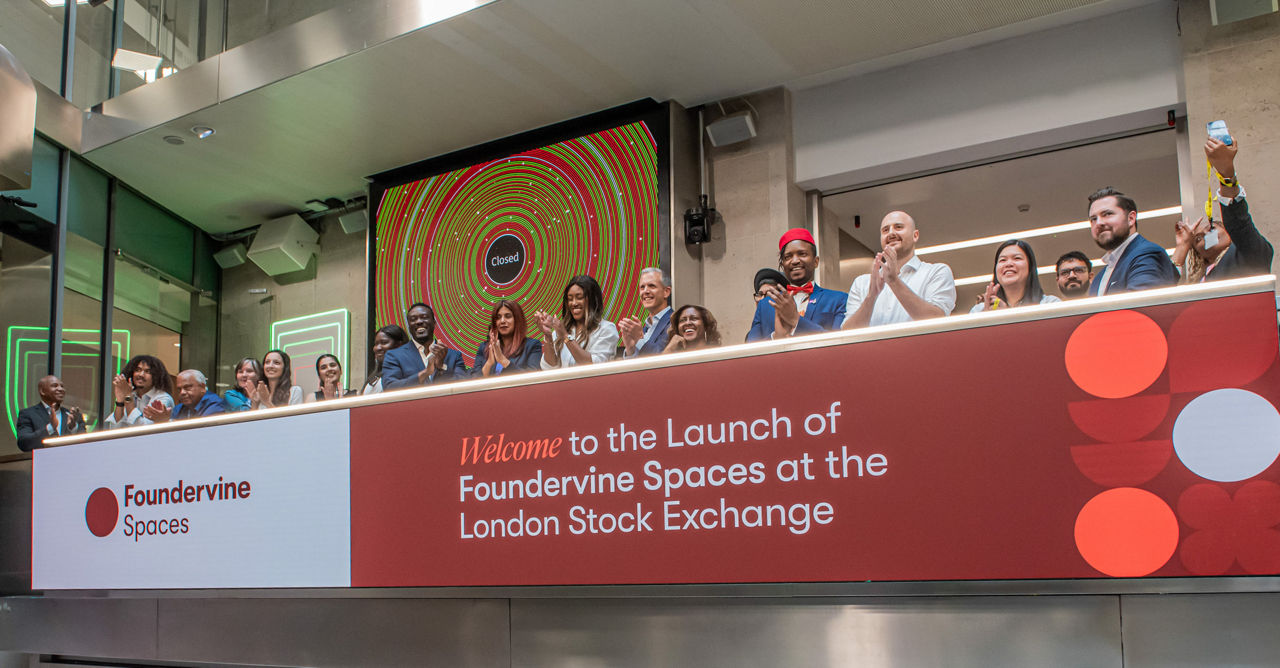 The team celebrating on the balcony at LSEG during the welcome ceremony.
