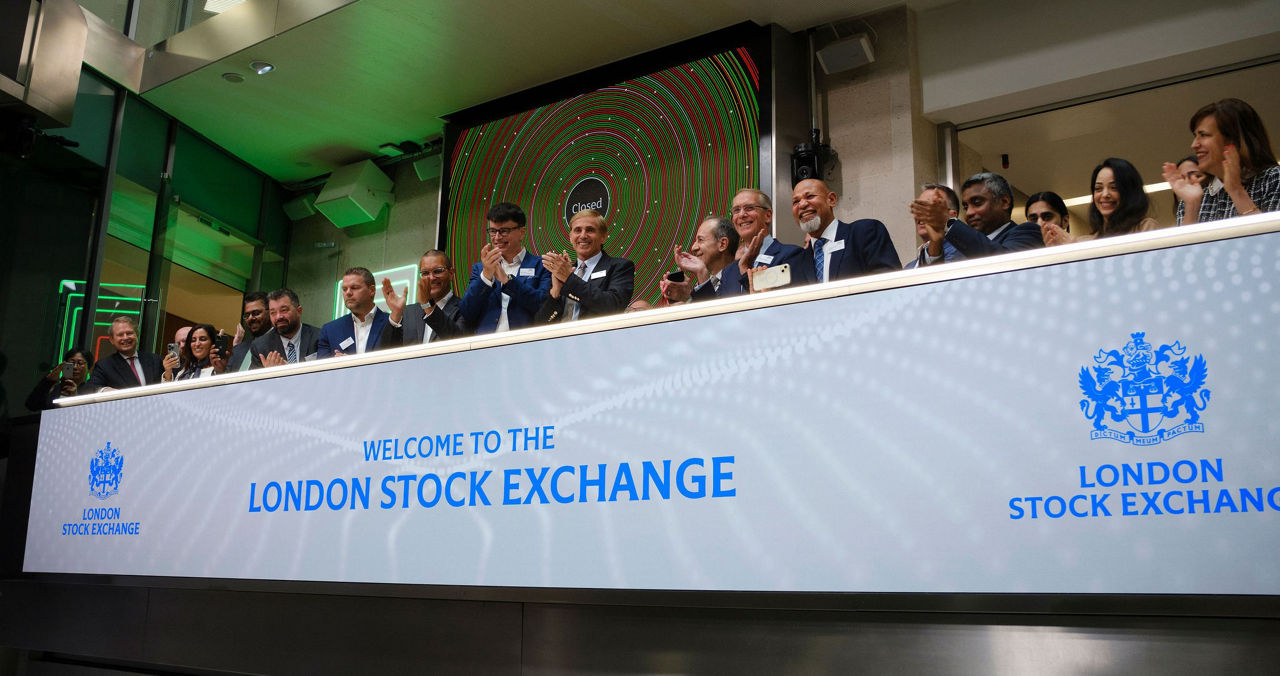 The team celebrating on the balcony at LSEG during the welcome ceremony.