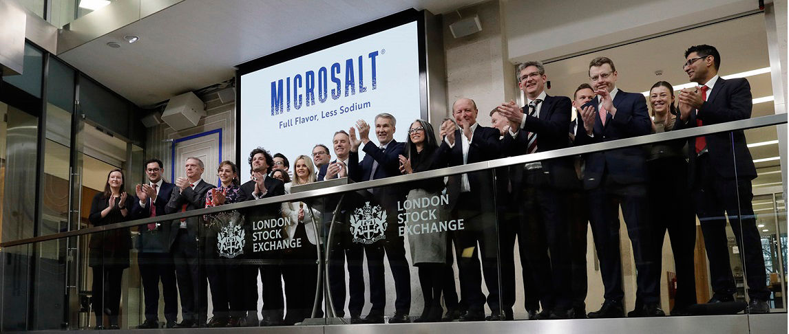 The team celebrating on the balcony at LSEG during the welcome ceremony.