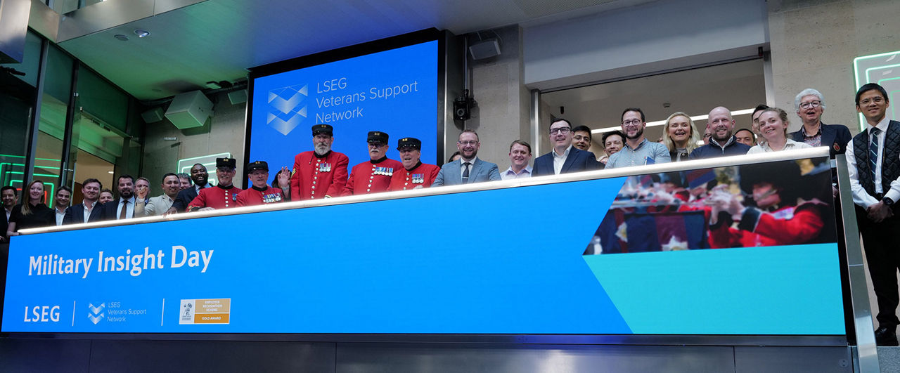 The team celebrating on the balcony at LSEG during the welcome ceremony.