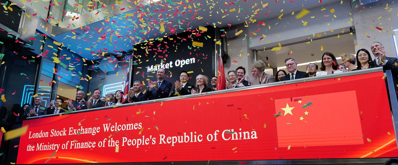 The team celebrating on the balcony at LSEG during the welcome ceremony.
