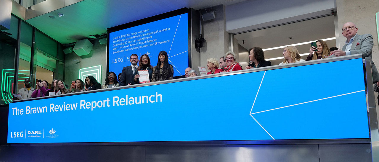 The team celebrating on the balcony at LSEG during the welcome ceremony.