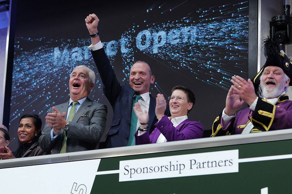 The team celebrating on the balcony at LSEG during the welcome ceremony.