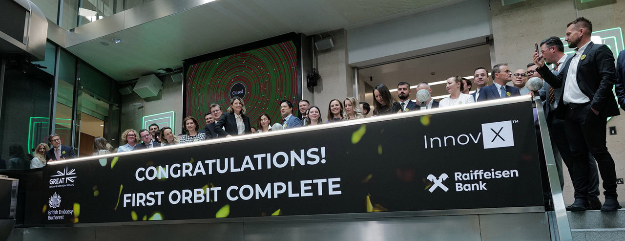 The team celebrating on the balcony at LSEG during the welcome ceremony.