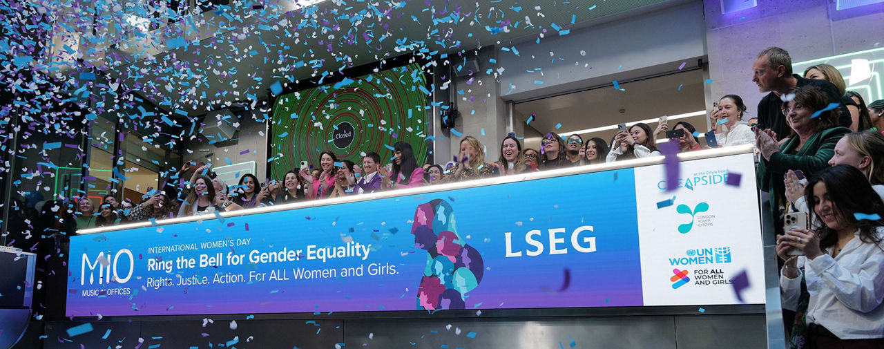 The team celebrating on the balcony at LSEG during the welcome ceremony.