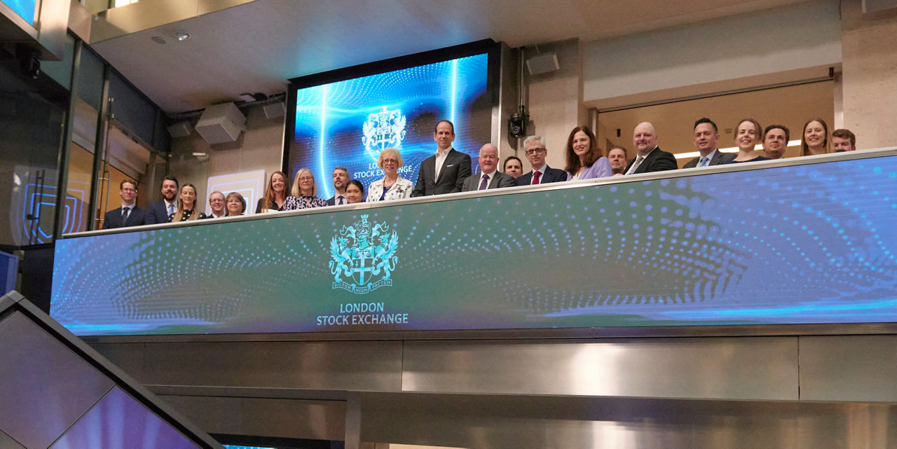 The team celebrating on the balcony at LSEG during the welcome ceremony.