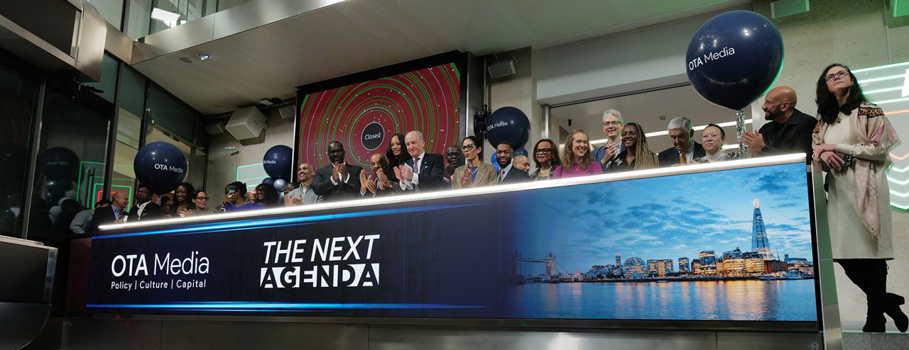 The team celebrating on the balcony at LSEG during the welcome ceremony.