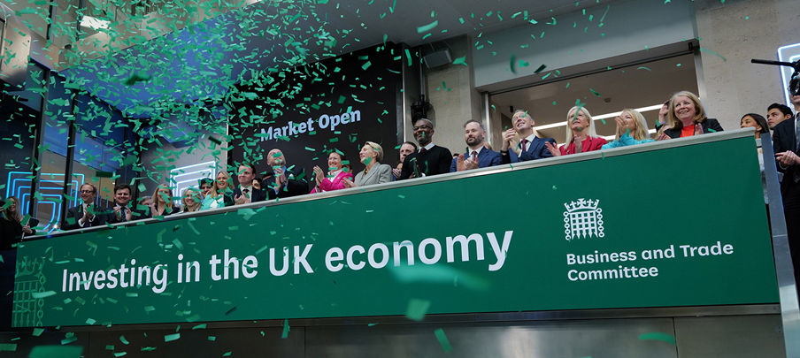 The team celebrating on the balcony at LSEG during the welcome ceremony.