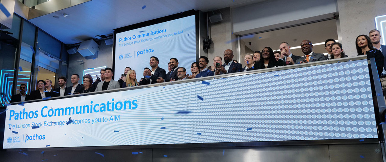 The team celebrating on the balcony at LSEG during the welcome ceremony.