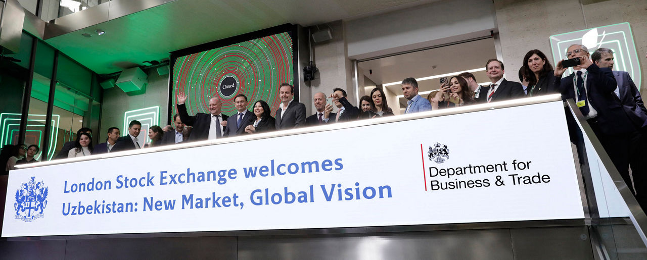 The team celebrating on the balcony at LSEG during the welcome ceremony.