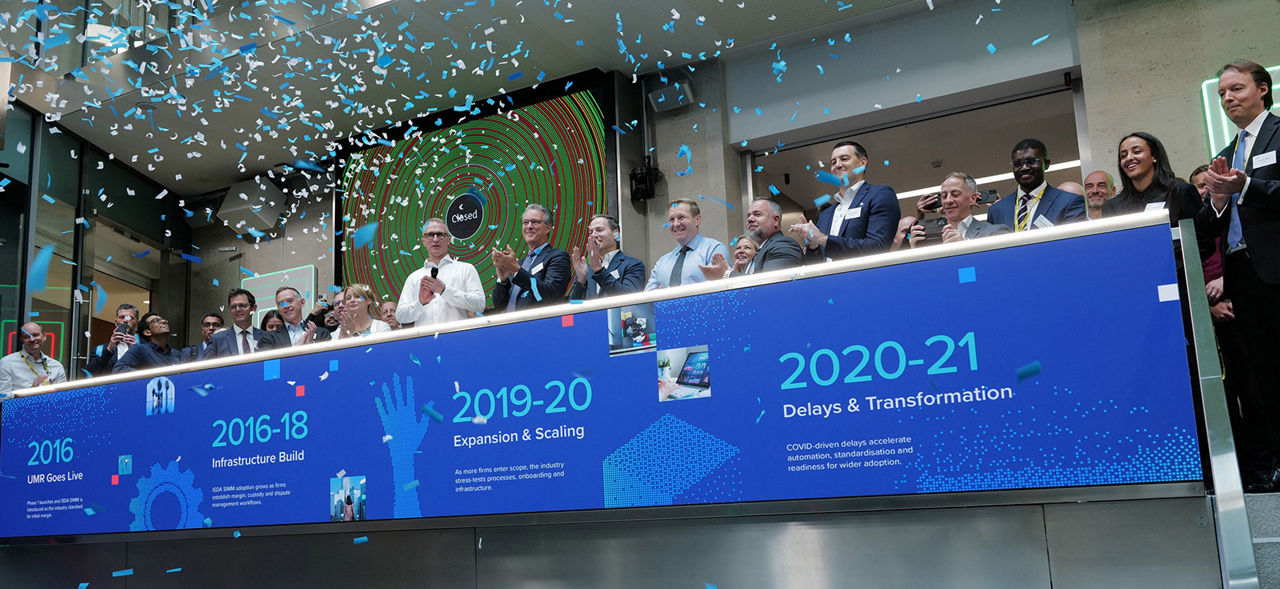 The team celebrating on the balcony at LSEG during the welcome ceremony.