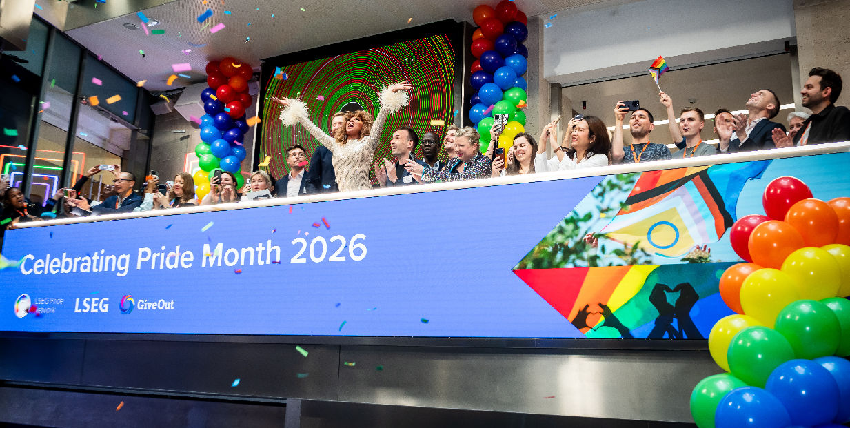 The team celebrating on the balcony at LSEG during the welcome ceremony.