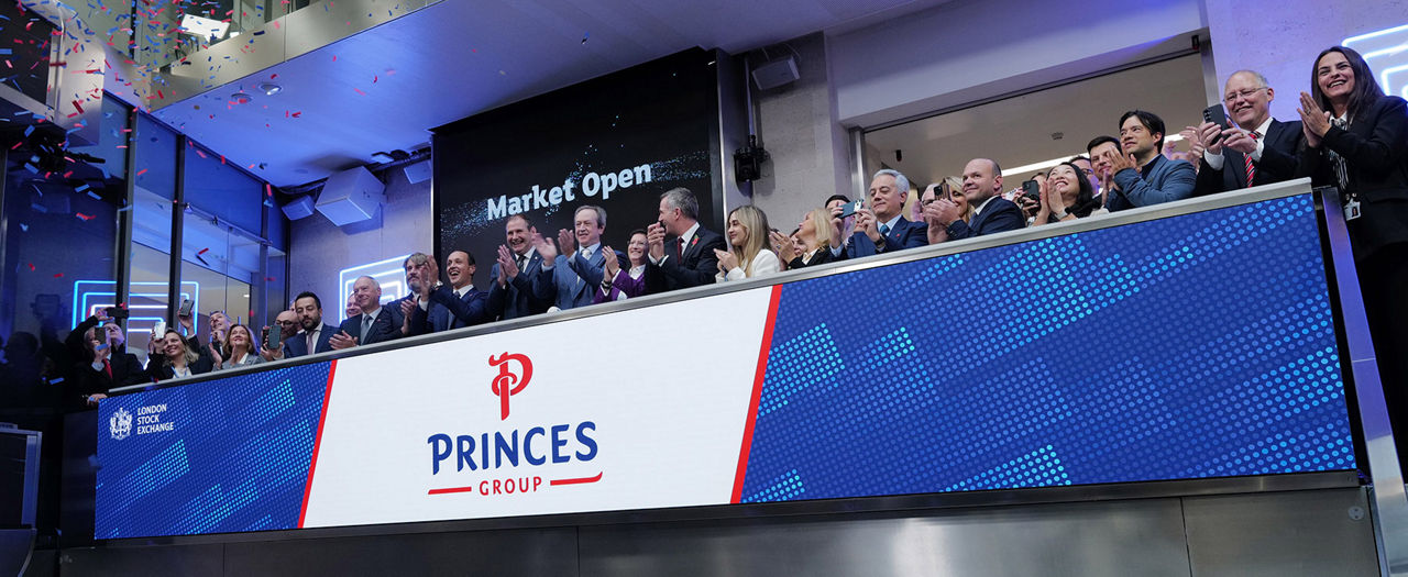 The team celebrating on the balcony at LSEG during the welcome ceremony.