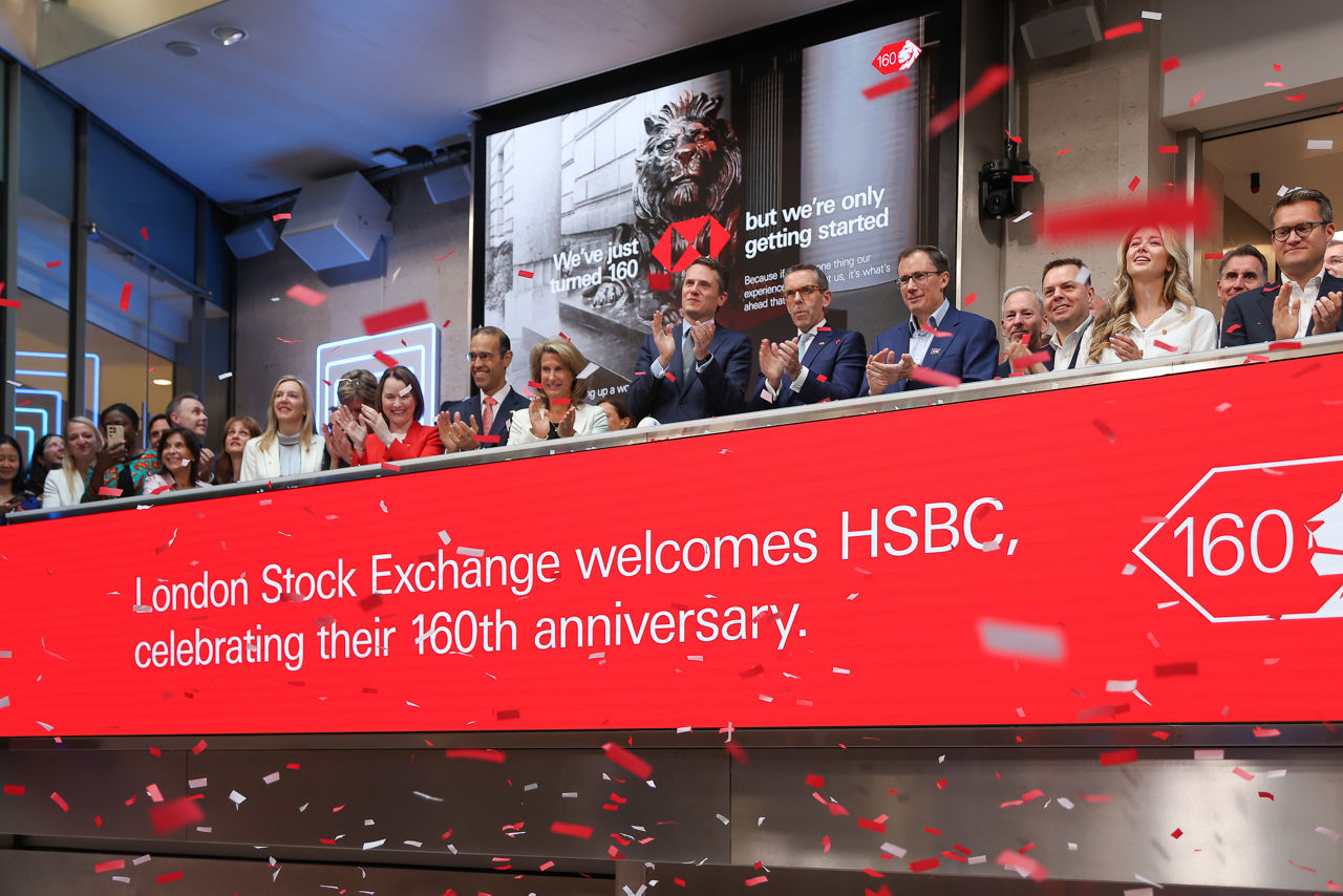 The team celebrating on the balcony at LSEG during the welcome ceremony.