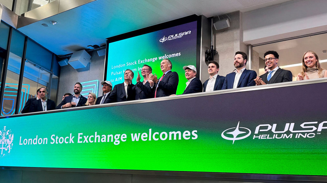 The team celebrating on the balcony at LSEG during the welcome ceremony.