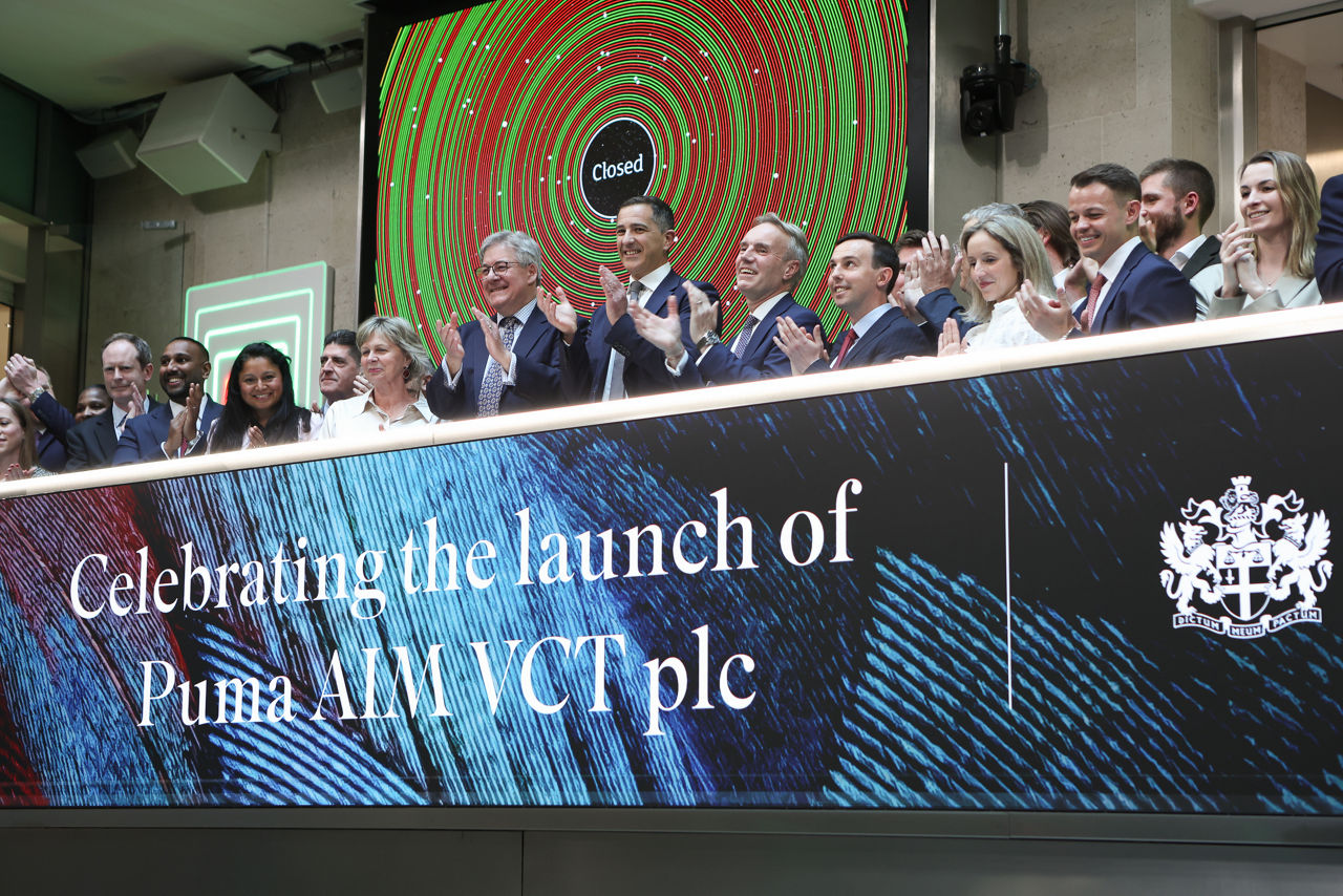 The team celebrating on the balcony at LSEG during the welcome ceremony.