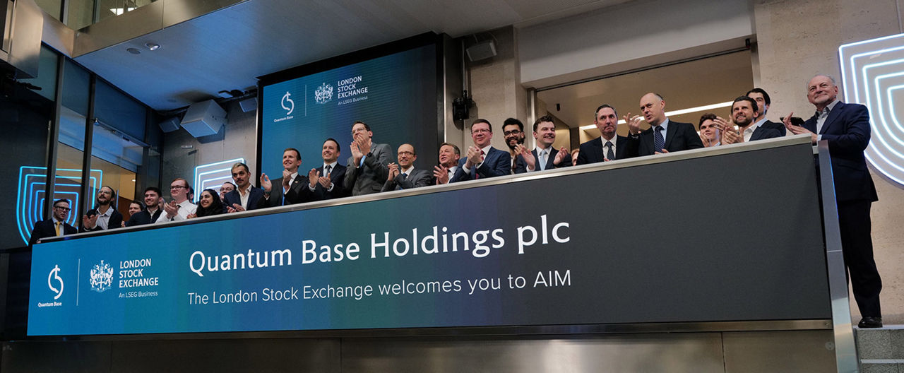 The team celebrating on the balcony at LSEG during the welcome ceremony.