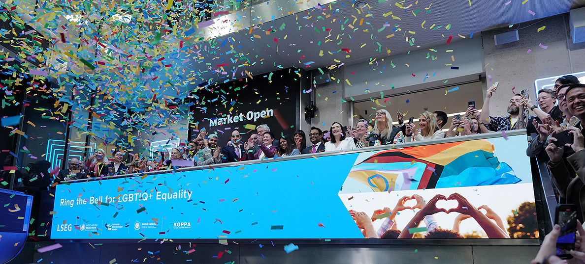 The team celebrating on the balcony at LSEG during the welcome ceremony.