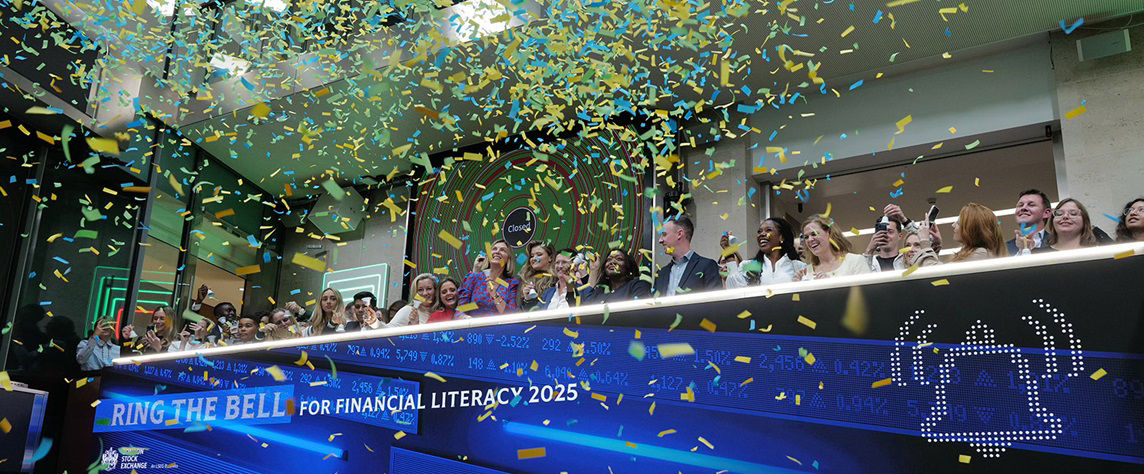 The team celebrating on the balcony at LSEG during the welcome ceremony.