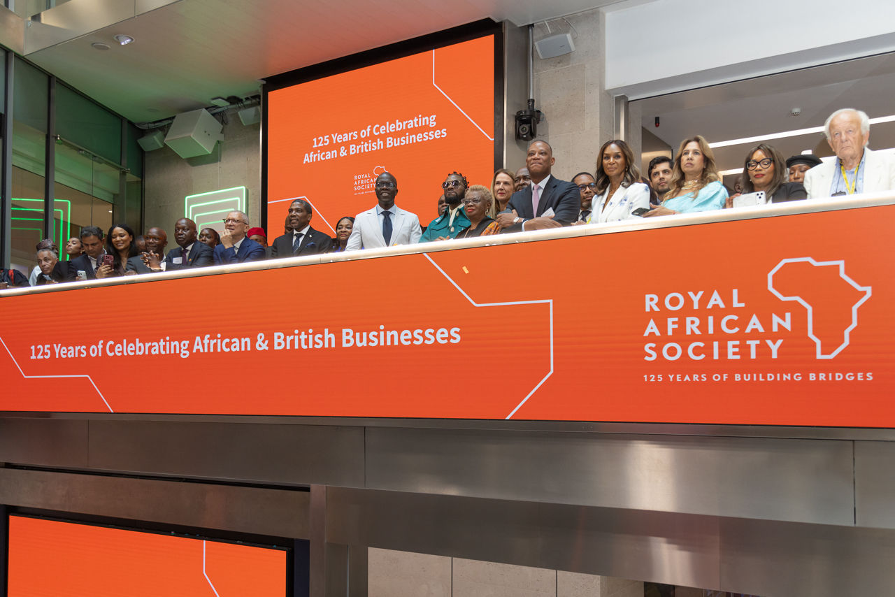 The team celebrating on the balcony at LSEG during the welcome ceremony.
