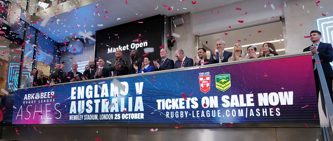 The team celebrating on the balcony at LSEG during the welcome ceremony.