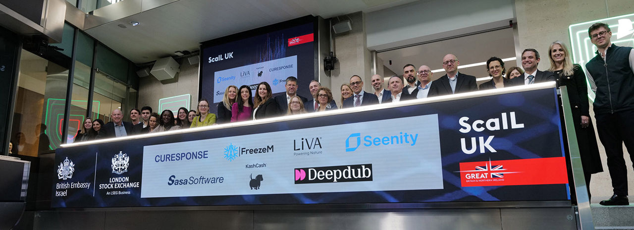 The team celebrating on the balcony at LSEG during the welcome ceremony.